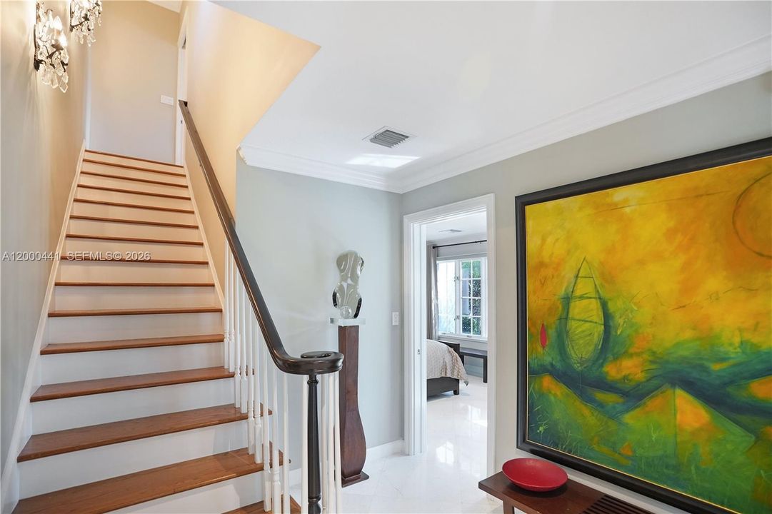 Charning staircase transitions to second floor.