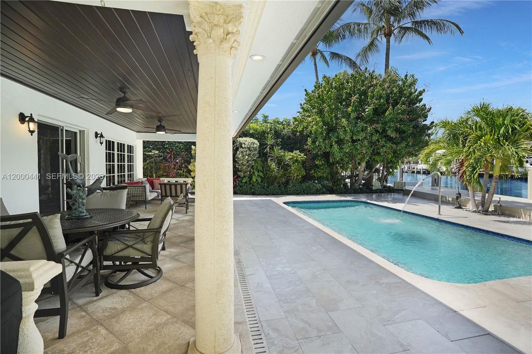 Large covered patio with wood ceiling.