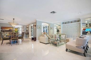Great room effect as living room flows towards dining room with adjacent bonus room & open sitting room/home office.