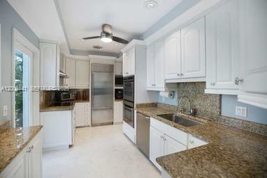 Classic white cabinetry with neutral granite an backsplash. Stainless steel appliances. Lots of counter space and storage.