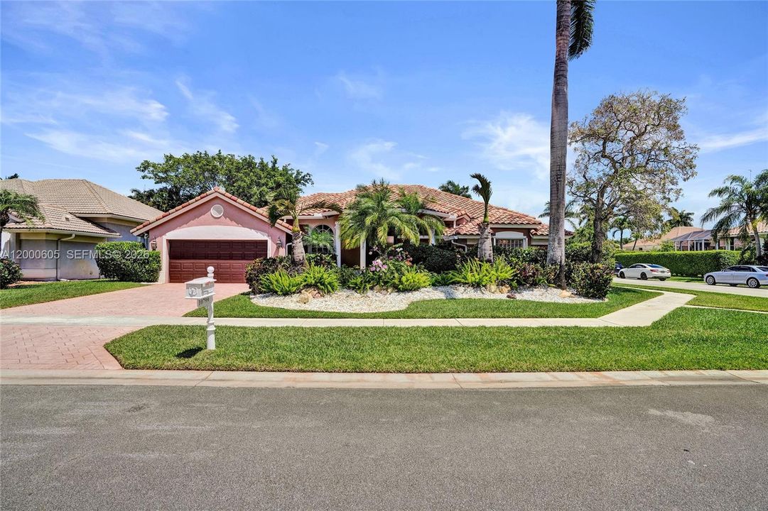 PERFECTLY MANICURED! WITH EXPENSIVE LANDSCAPING! LOTS OF ORCHIDS TOO!