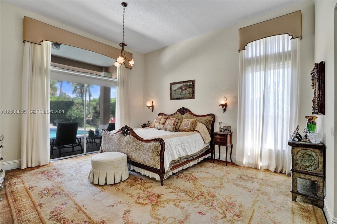 DESIGNER PRIMARY BEDROOM WITH MAHOGANY WOOD FLOORS UNDER RUG!