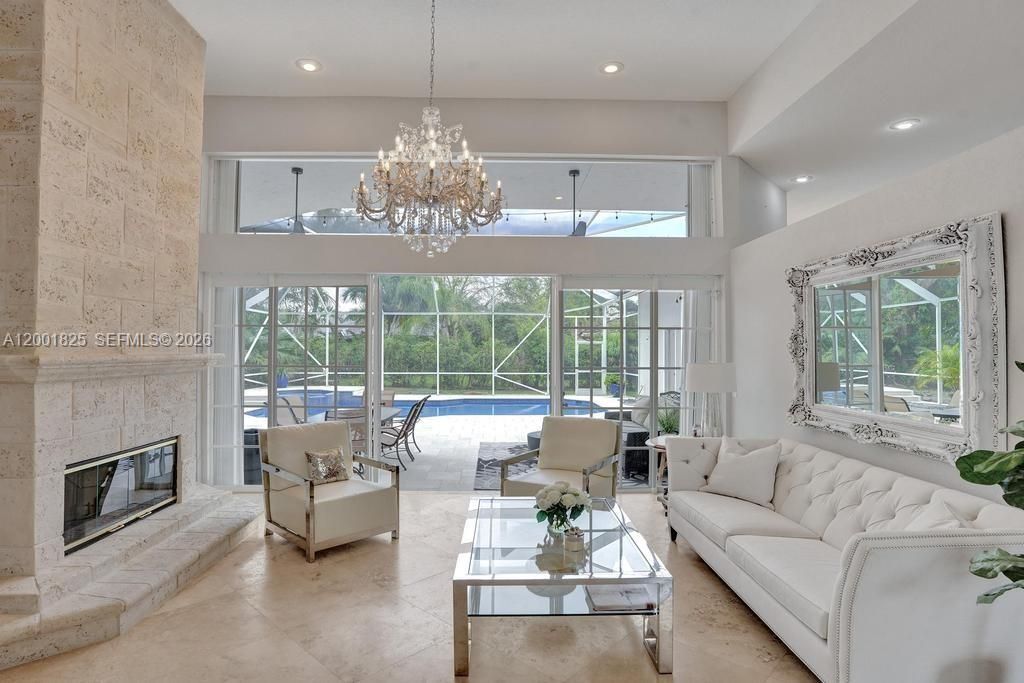 Is accented by a Coral Rock fireplace and high volume ceilings!