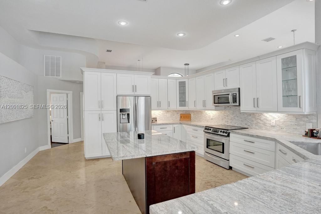 Reverse kitchen view shows off the natural stone counter tops!