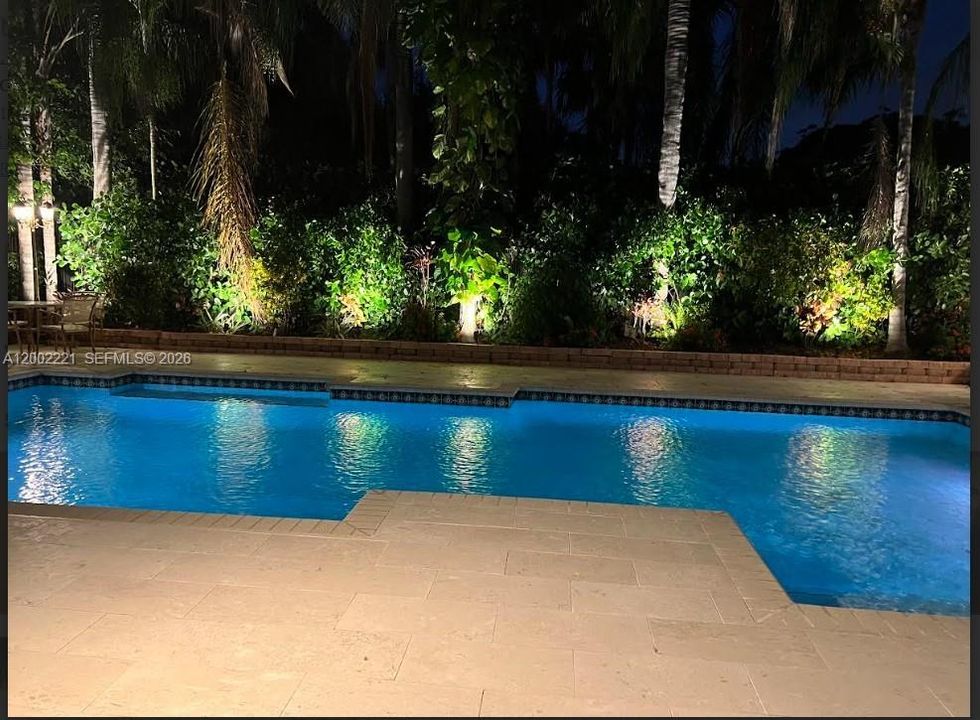 Spectacular night shot with the landscaping lights on in the background