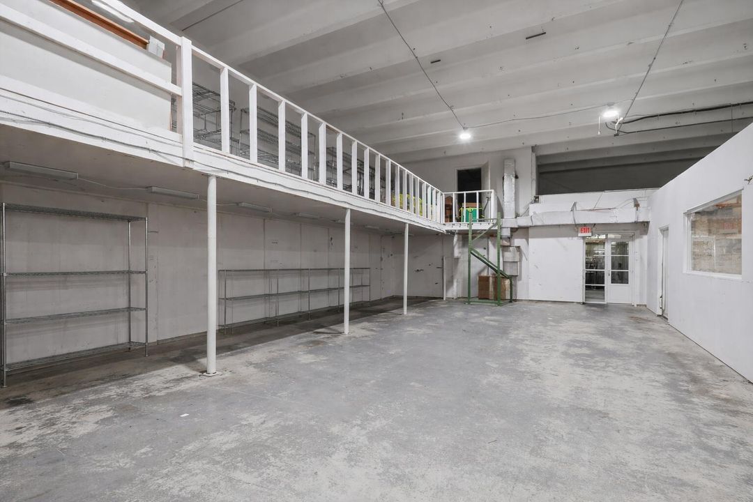 Empty warehouse with mezzanine shelving