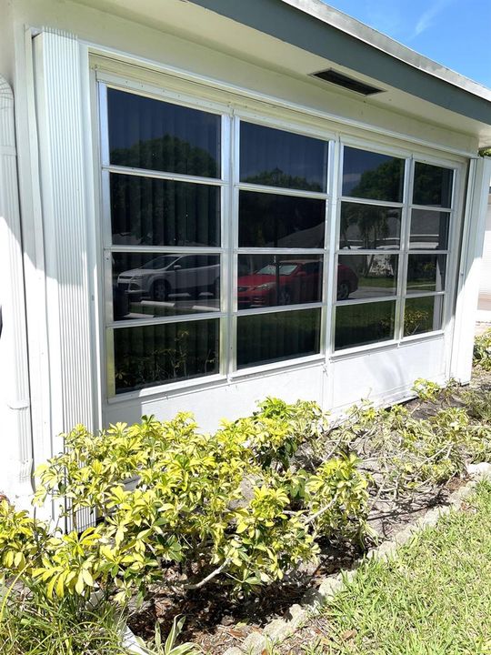Accordion shutters on Florida room windo