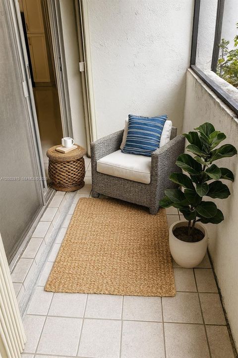 Virtually staged screened balcony.