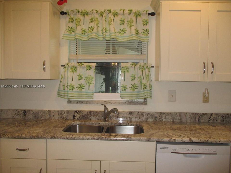 Granite countertops/cream colored cabinets & dual sink