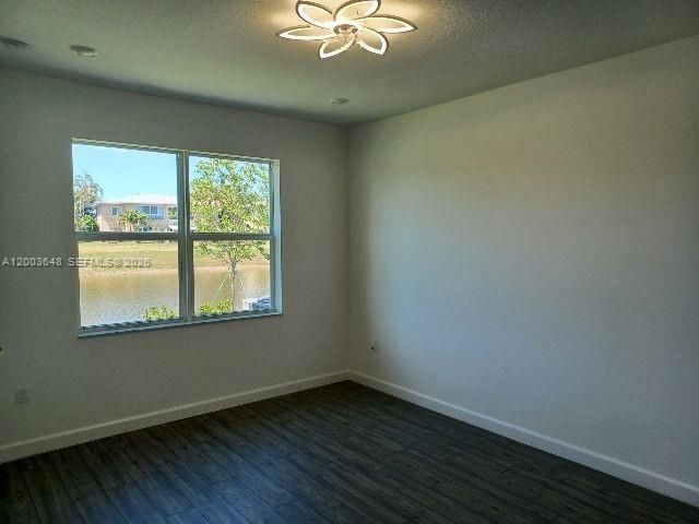 Master bedroom with views of water and elegant fan with built in lighting