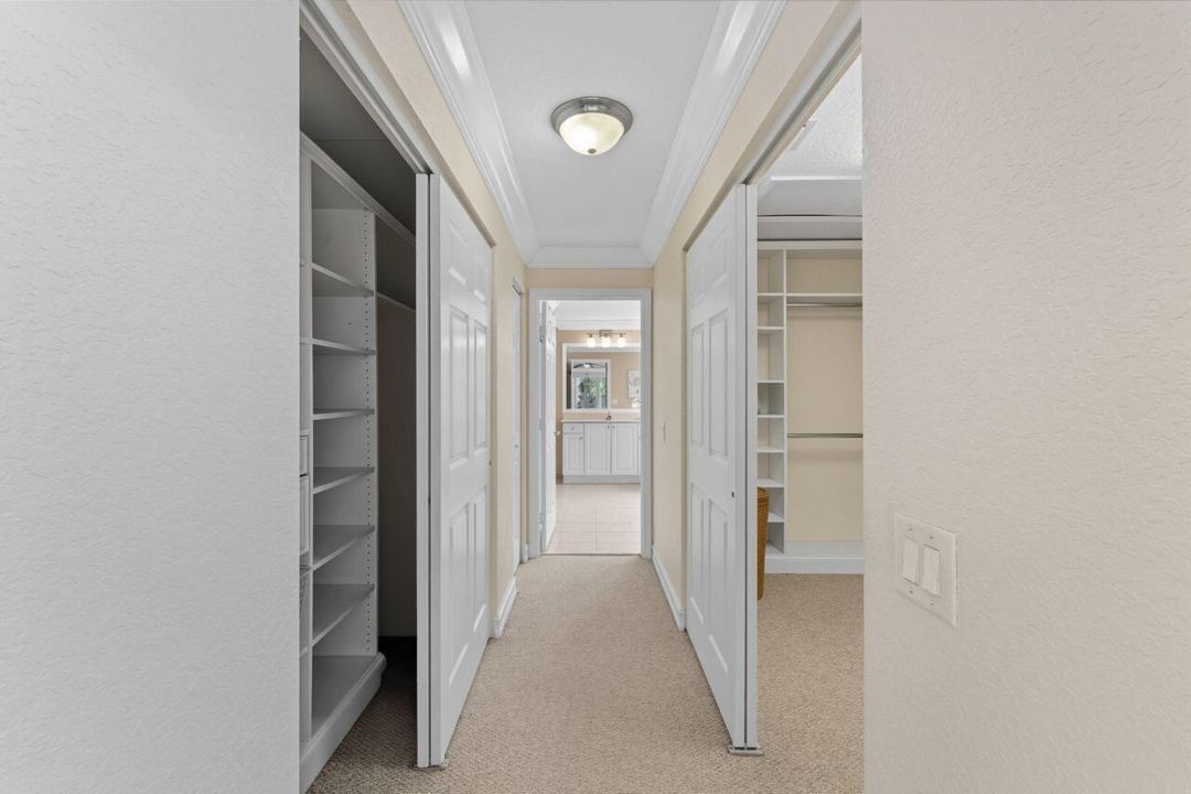 Primary hallway to bath- dual closets