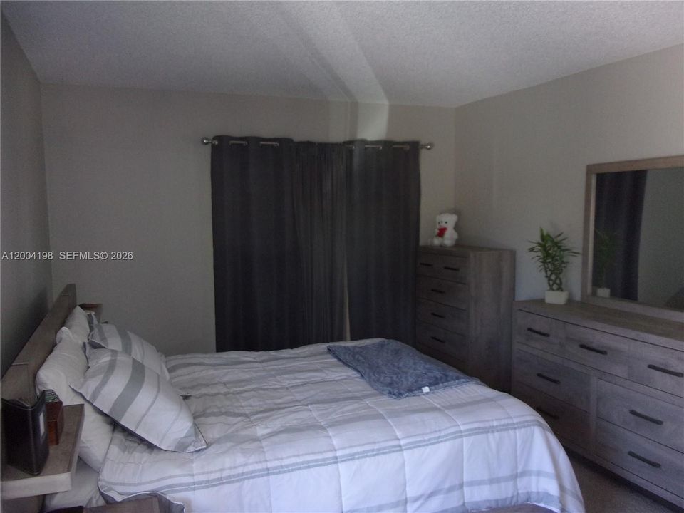 The primary bedroom has a walkin closet, private bath and sliding doors to the screen patio