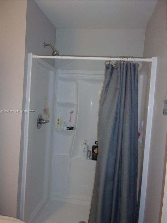 The new shower install has great storage for your soaps and other needs