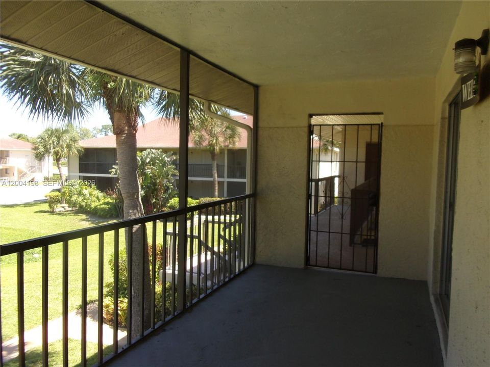 The screen patio is large enough for outdoor dining and just enjoying the green space view