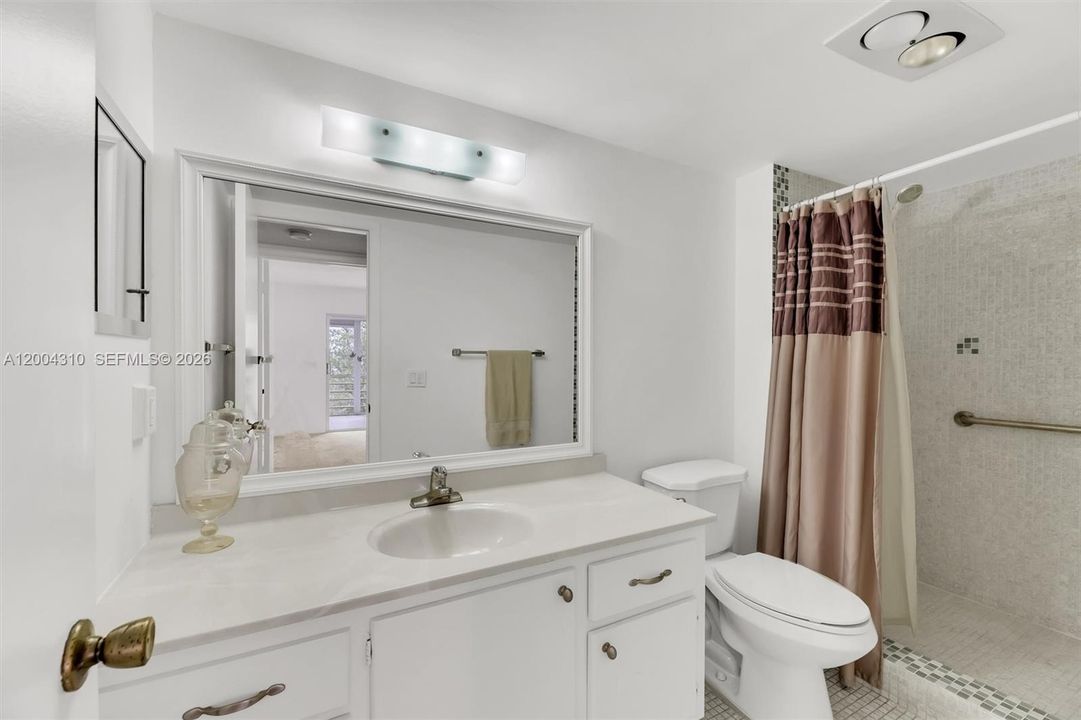 Bathroom #1 showing vanity & partial shower area