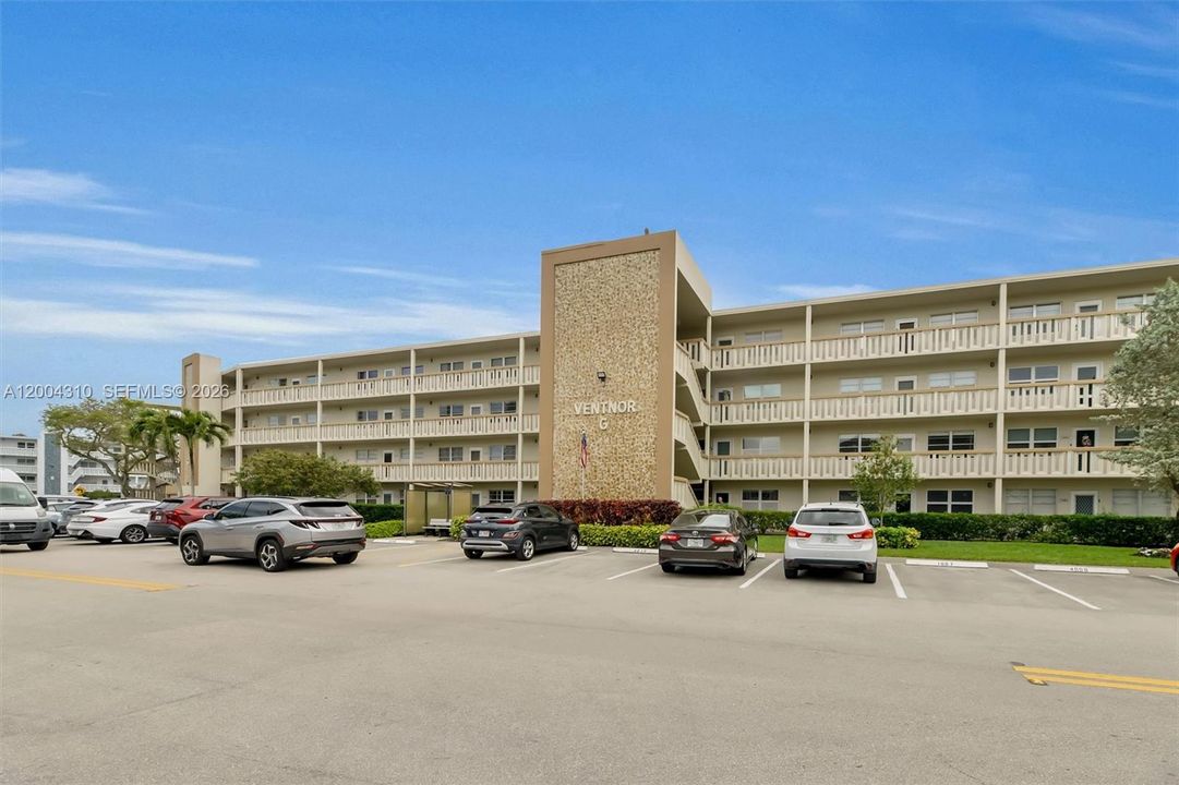 Wide building front showing full length, & parking