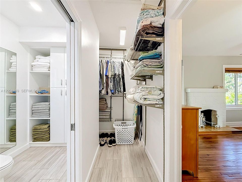 Two walk-in closets on either side of entrance to bathroom