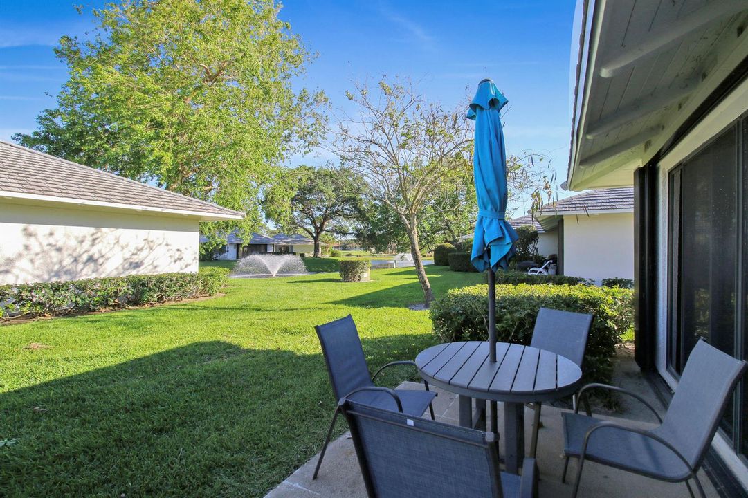 Back patio with golf and fountain views.