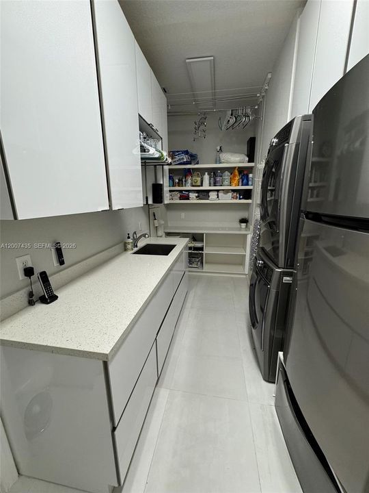 Laundry room with TV on opposite wall (not in picture)