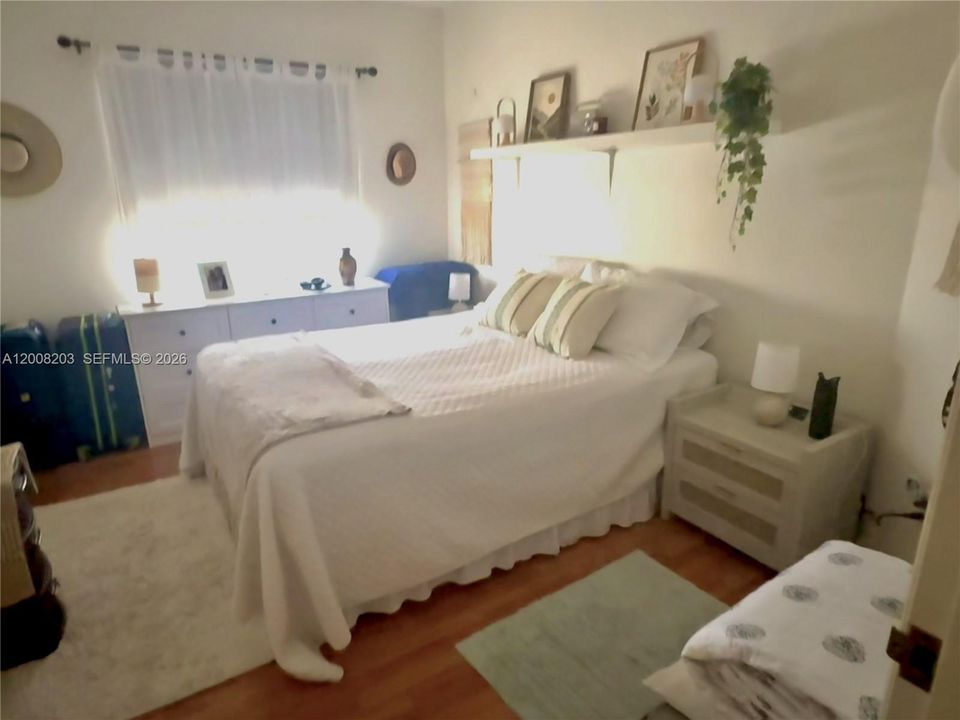 Bright bedroom with natural light and a spacious wall-to-wall closet.