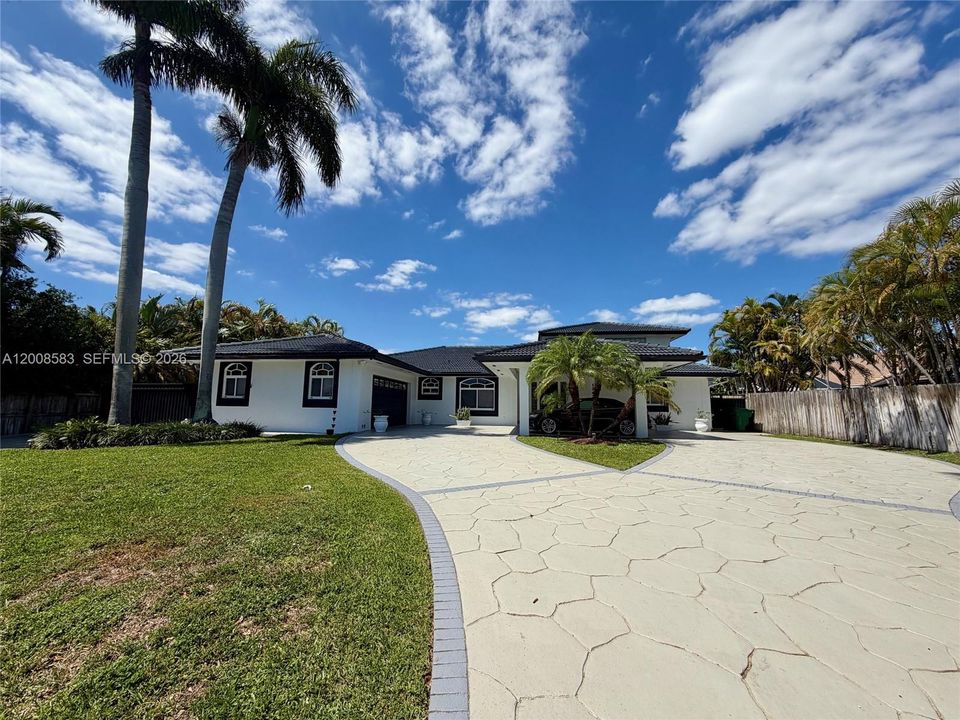Left side of driveway and home