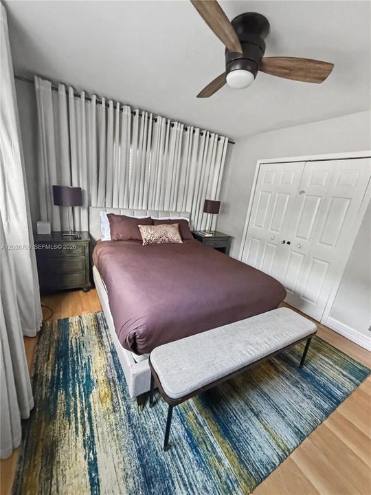 Primary bedroom — comfortable retreat with ceiling fan and quality finishes