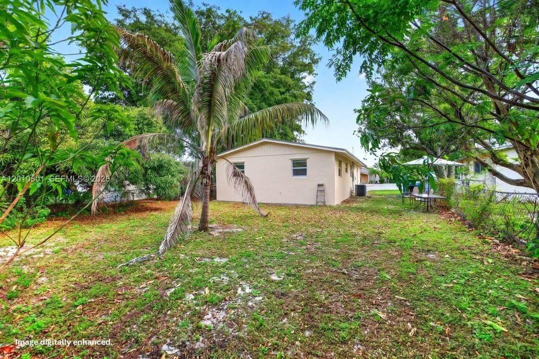 Nice palm / coconut tree. Back of house virtually enhanced / cleaned