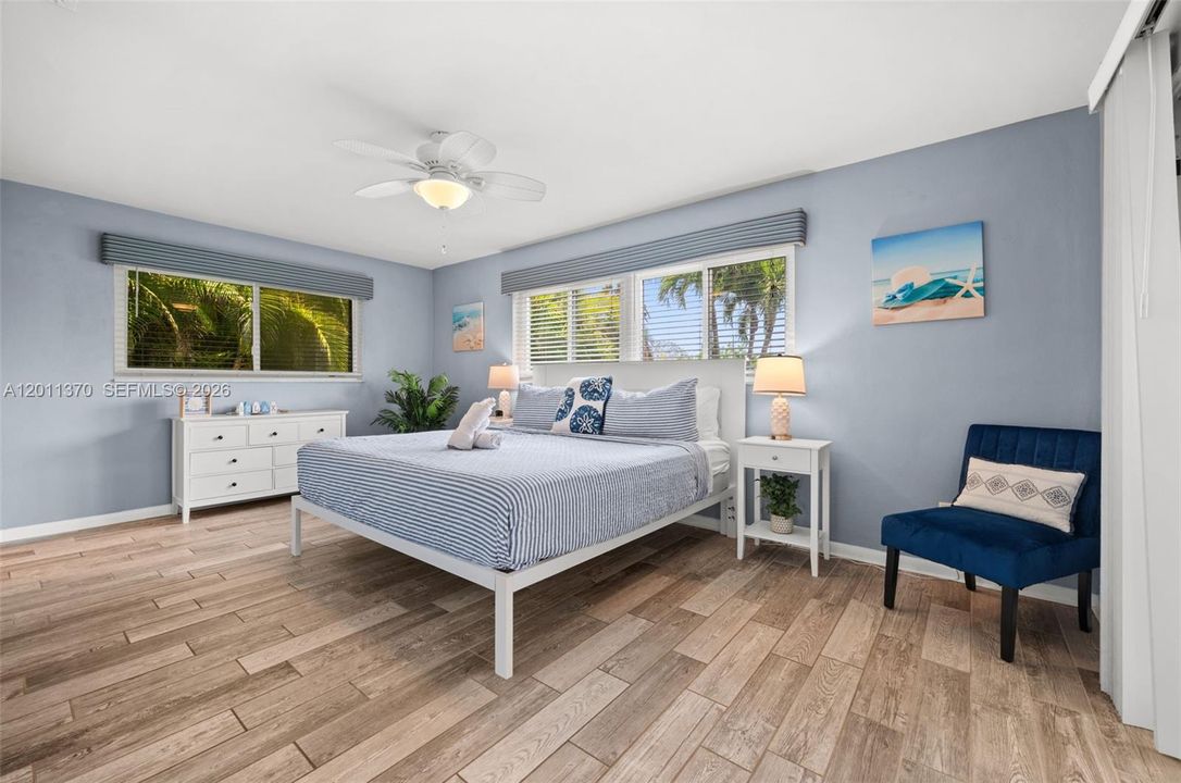 Primary bedroom with lots of windows for natural light