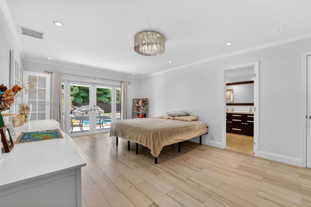 Impact French doors open to the pool and garden, ideal for enjoying morning coffee in a tranquil setting.