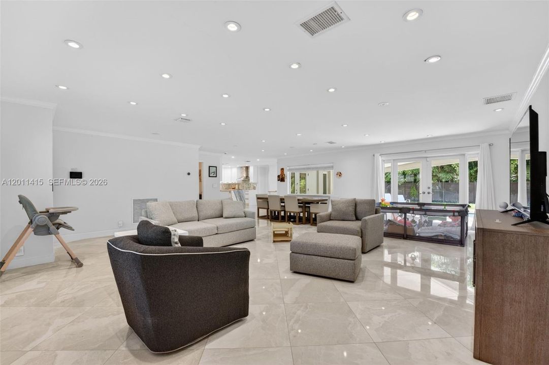 French doors seamlessly connect the indoor space to the patio and pool area, creating an easy flow for indoor-outdoor living and entertaining.