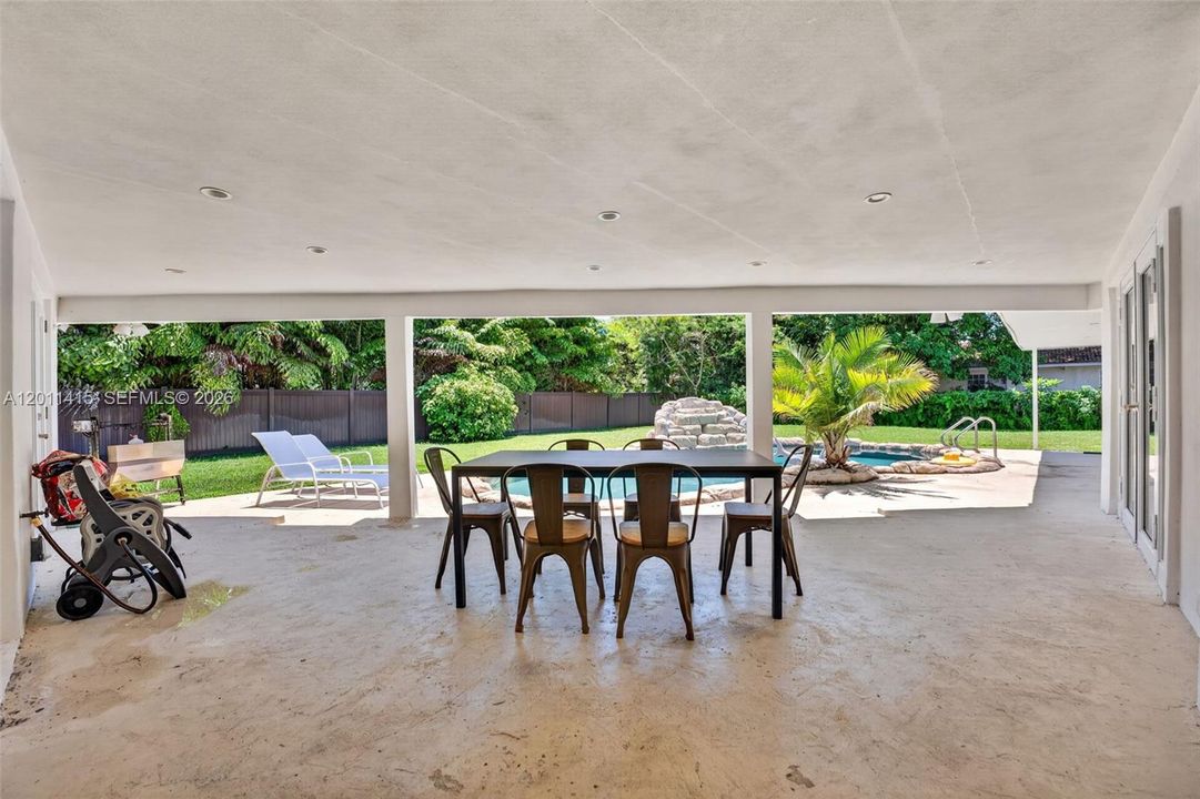 Oversized covered patio overlooking the pool and yard—perfect for entertaining or escaping the South Florida sun and afternoon rain showers while still enjoying the outdoors.
