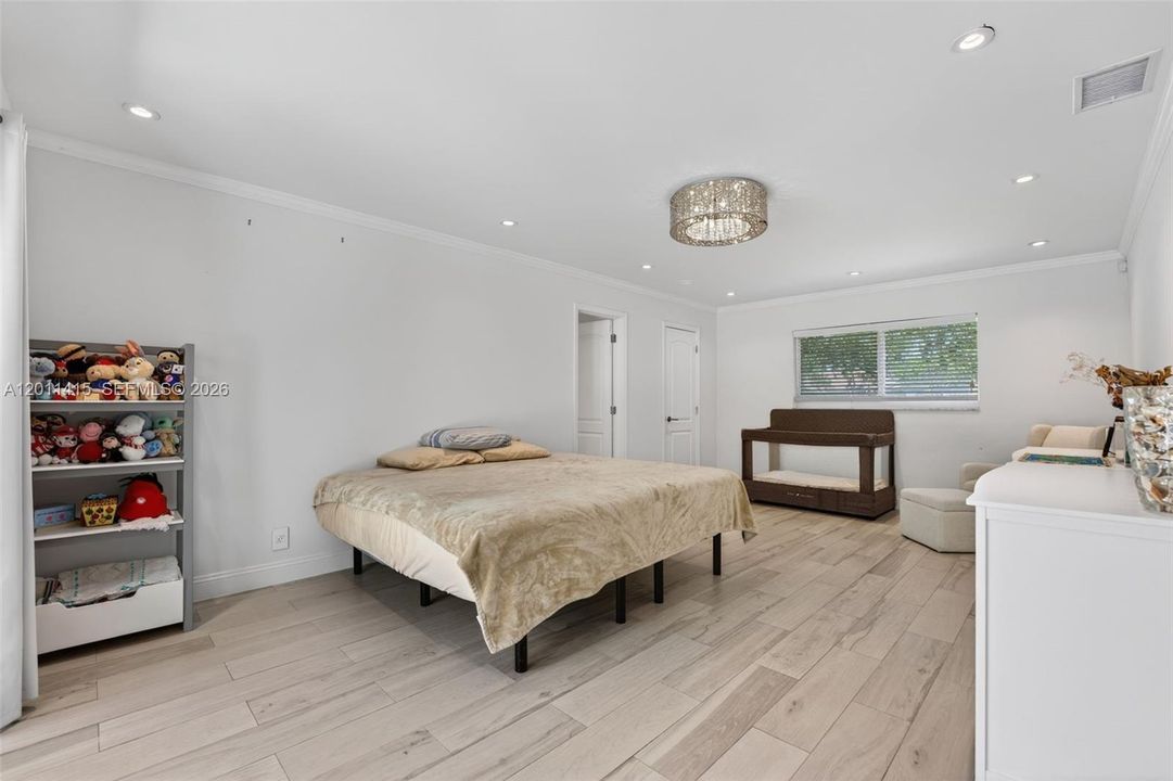 Oversized primary suite with generous additional space, perfect for a sitting area, gym, or home office setup.