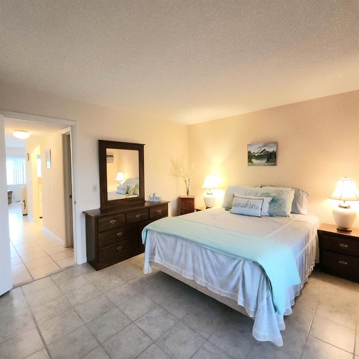 Hallway with closets and full bath