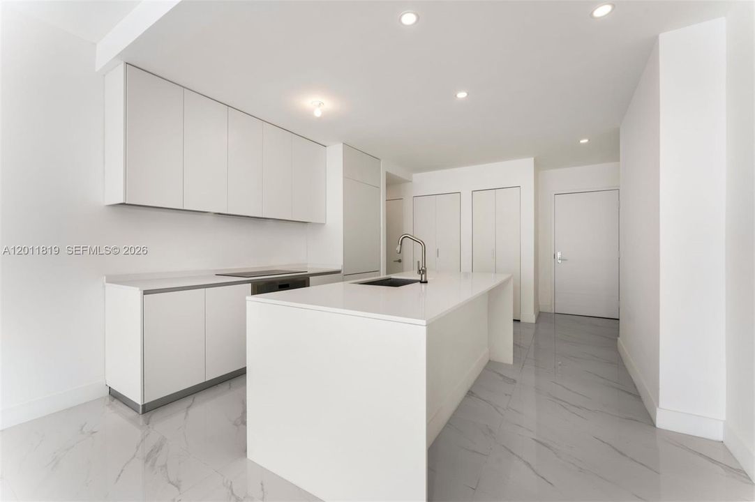 Modern chef’s kitchen equipped with custom Italian cabinetry, premium Miele appliances, integrated stone countertops, and a waterfall island perfect for entertaining.