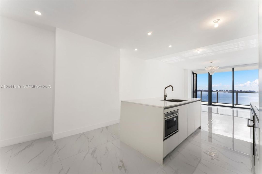 Modern chef’s kitchen equipped with custom Italian cabinetry, premium Miele appliances, integrated stone countertops, and a waterfall island perfect for entertaining.