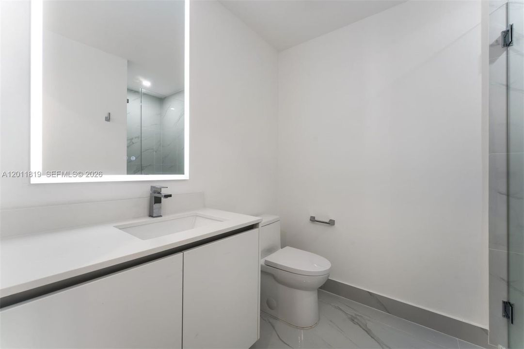Elegant secondary bathroom with high-end European fixtures, modern vanity, and curated finishes consistent with Aria Reserve’s luxury design standards.