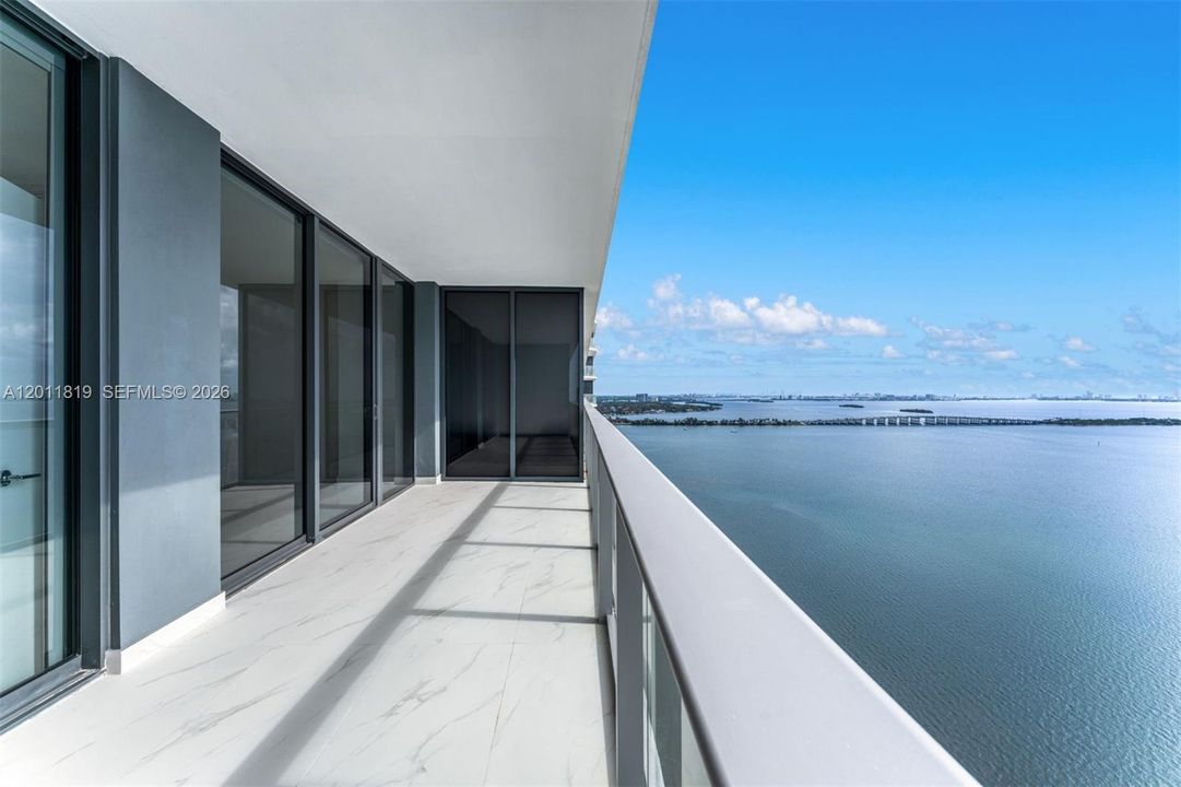 Breathtaking panoramic sunrise views of Biscayne Bay and the Atlantic Ocean from the expansive private terrace of Aria Reserve #2504 in Edgewater, Miami.