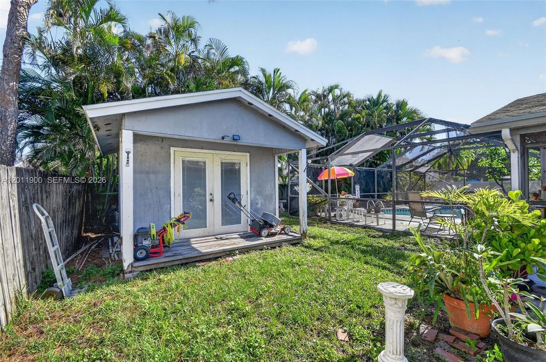 Fenced backyard and A/Ced work shed with covered patio.