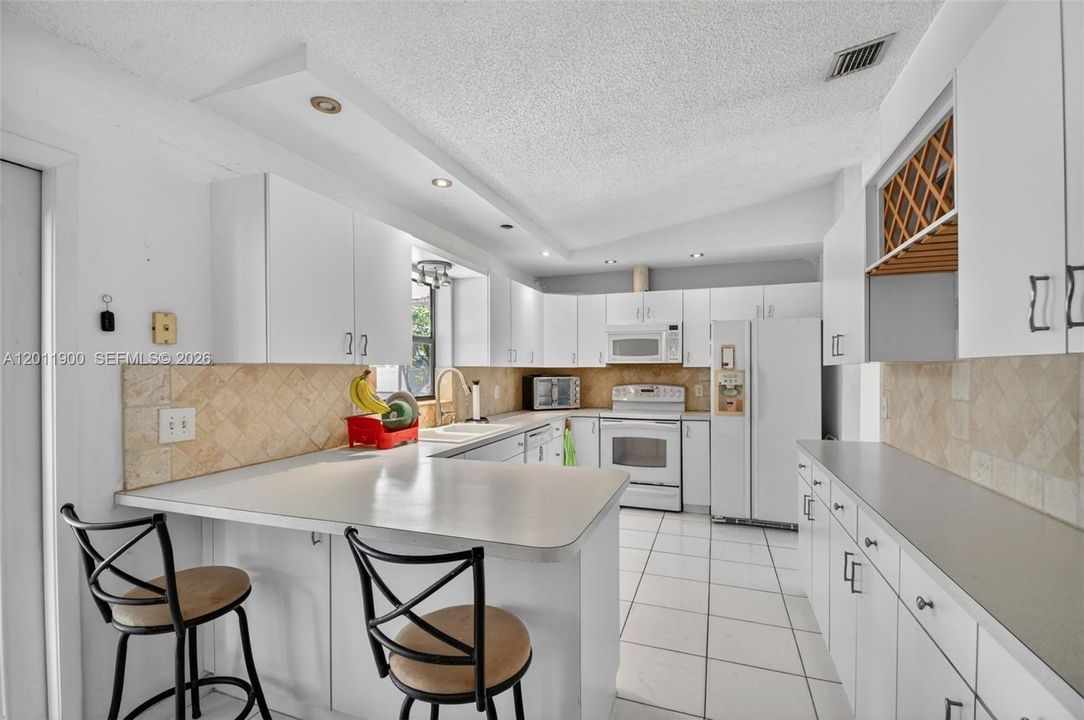Plenty of storage in the large kitchen that overlooks your pool.