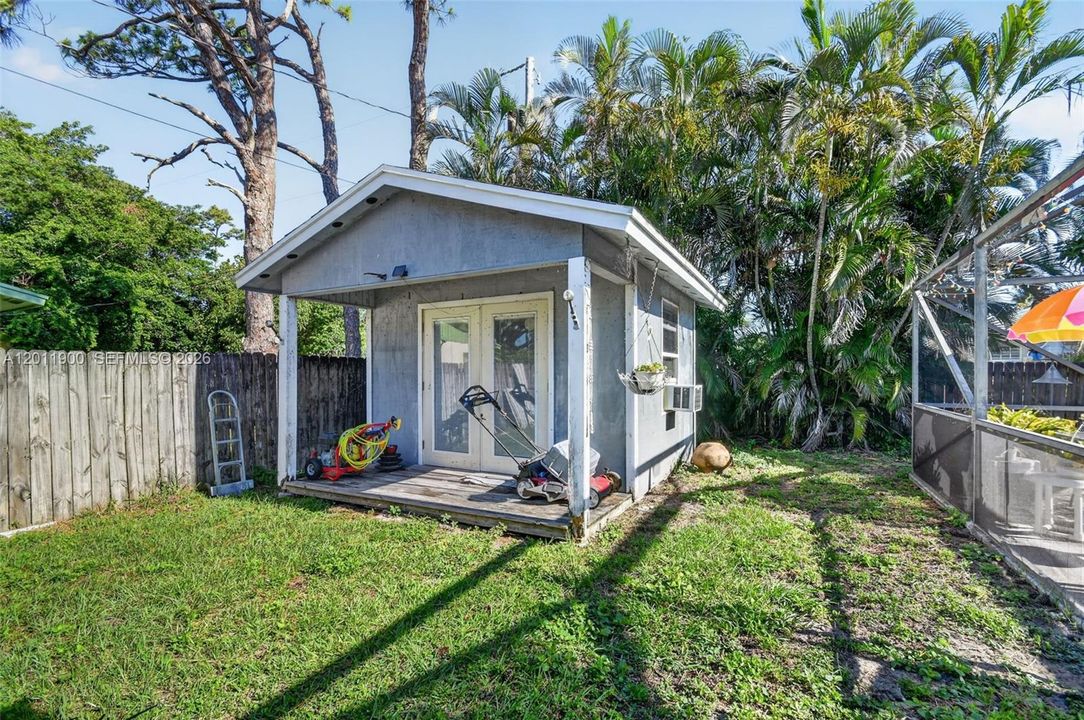 Fenced backyard and A/Ced work shed with covered patio.