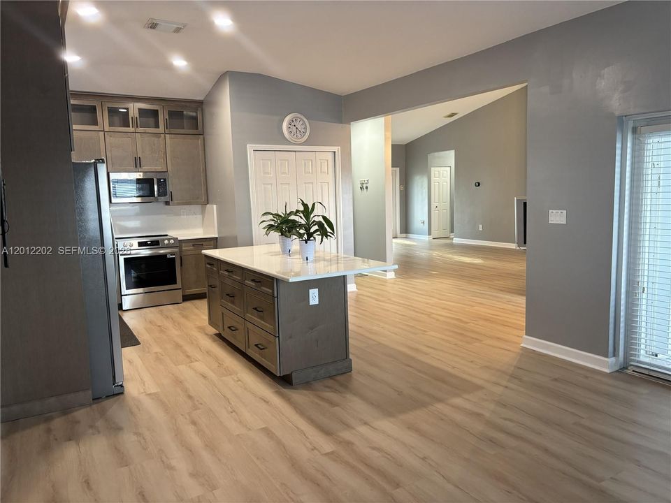 Completely Remodeled Kitchen with Stainless Steel Appliances, Quartz Countertops and New Cabinetry.