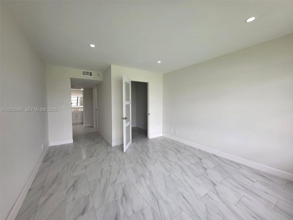 Spacious master bedroom with walk-in closet and bonus space for personal office