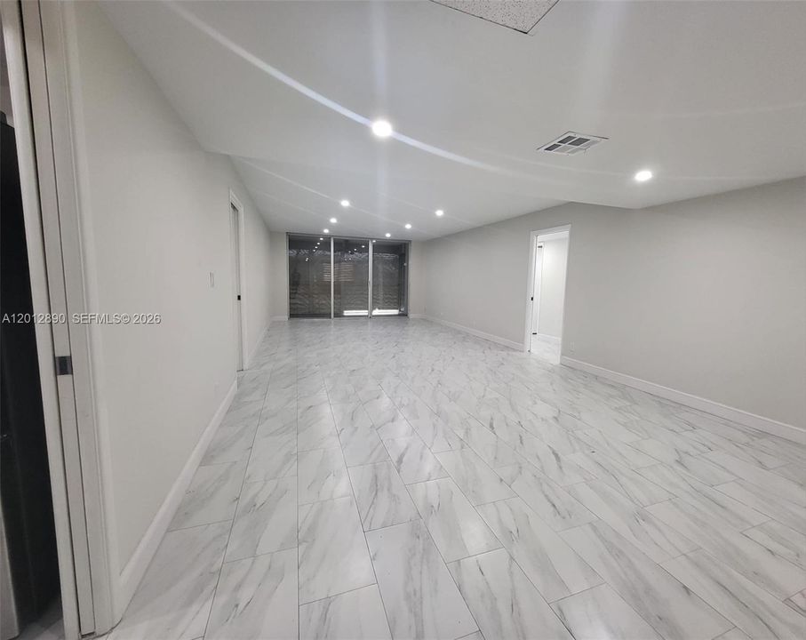 Open concept living and dining room (impact shutters on patio)