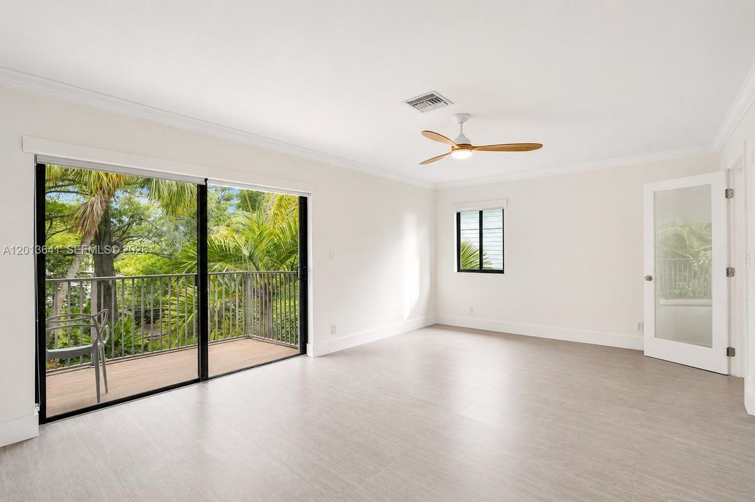 Private balcony off the primary bedroom overlooking a lush back oasis.