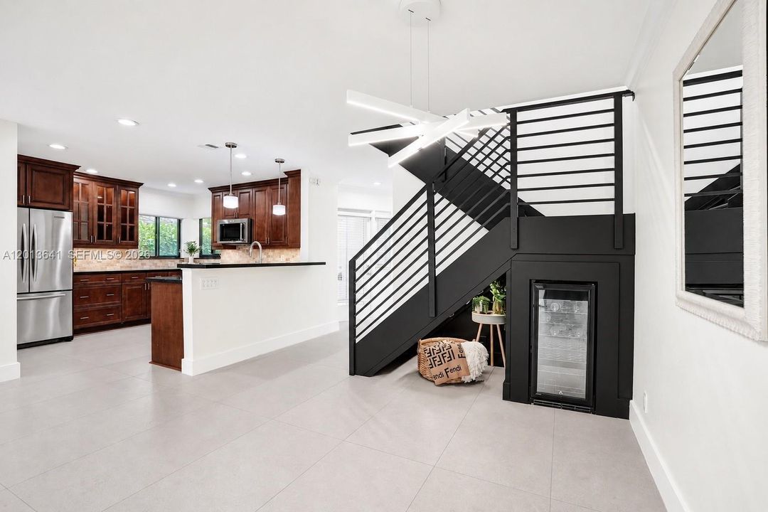 New contemporary staircase and wine fridge.