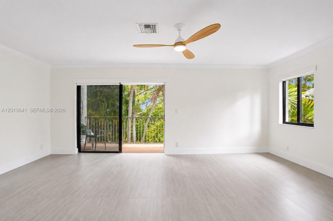 Spacious primary bedroom, with seating area.