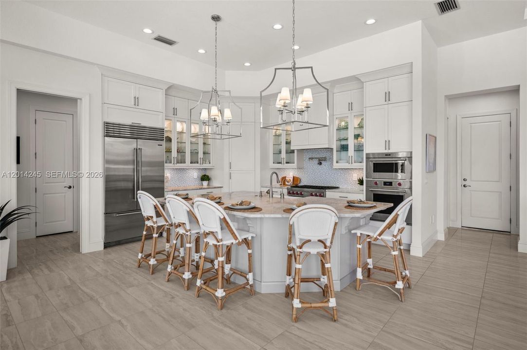 Island kitchen with custom countertop and Sub-Zero refrigerator