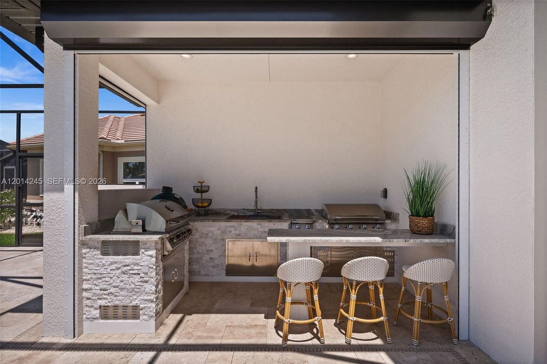 Full outdoor kitchen with grill, smoker, side burners and flat top grill
