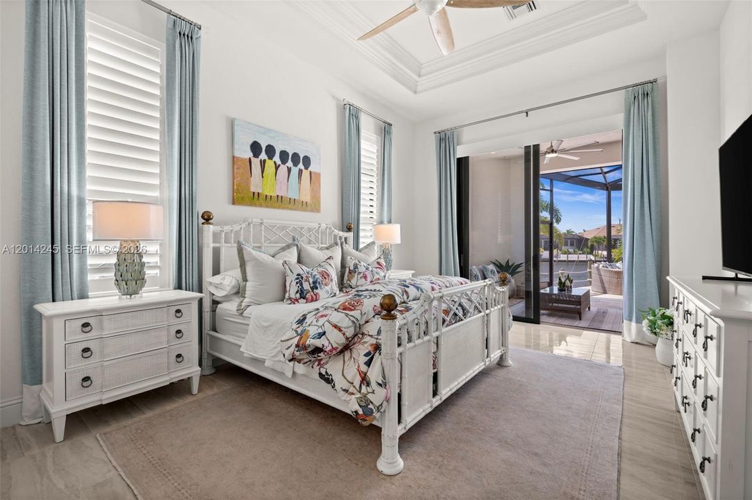 Primary bedroom with sliding door to the lanai and pool area