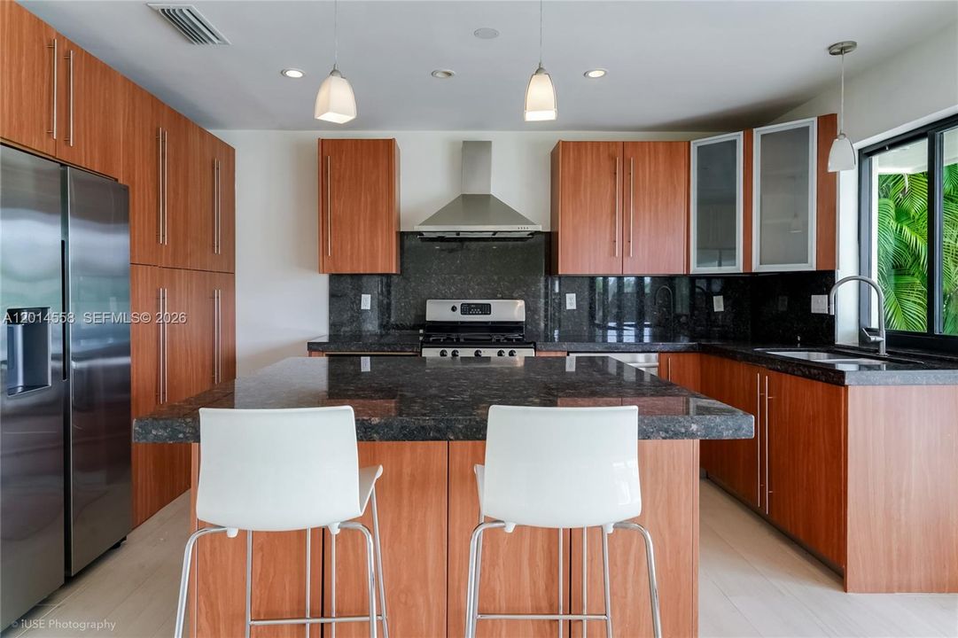 This inviting kitchen boasts an abundance of thoughtfully designed cabinet space, making it the dream workspace for the chef in the family!
